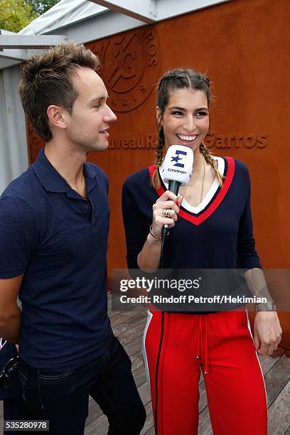 Host Cyril Feraud and journalist Laury Thilleman attend Day Height of the 2016 French Tennis Open at Roland Garros on May 29, 2016 in Paris, France.