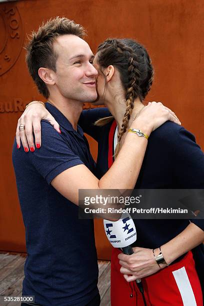 Host Cyril Feraud and journalist Laury Thilleman attend Day Height of the 2016 French Tennis Open at Roland Garros on May 29, 2016 in Paris, France.
