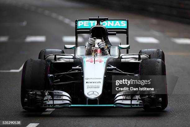 Lewis Hamilton of Great Britain and Mercedes GP celebrates in the car as he approaches Parc Ferme after winning the Monaco Formula One Grand Prix at...