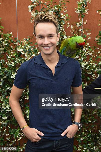 Cyril Feraud with a Parrot attend day eight of the 2016 French Open at Roland Garros on May 29, 2016 in Paris, France.