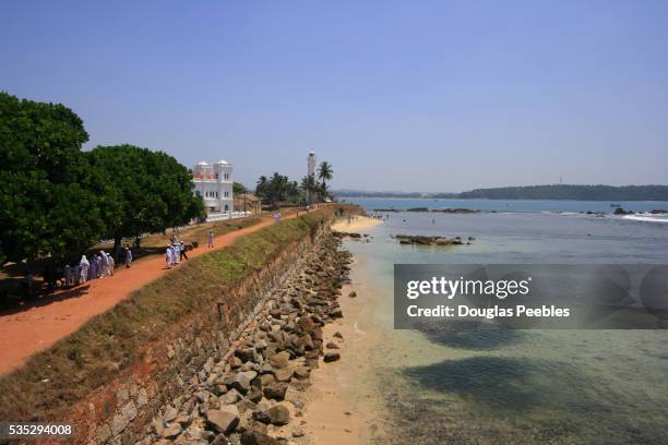 galle mosque and lighthouse above original fort ramparts - galle fort stock pictures, royalty-free photos & images