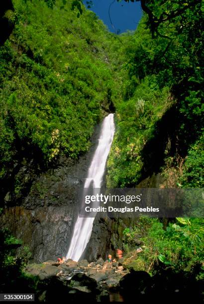 water cascading down steep rocks - tahiti waterfall stock pictures, royalty-free photos & images