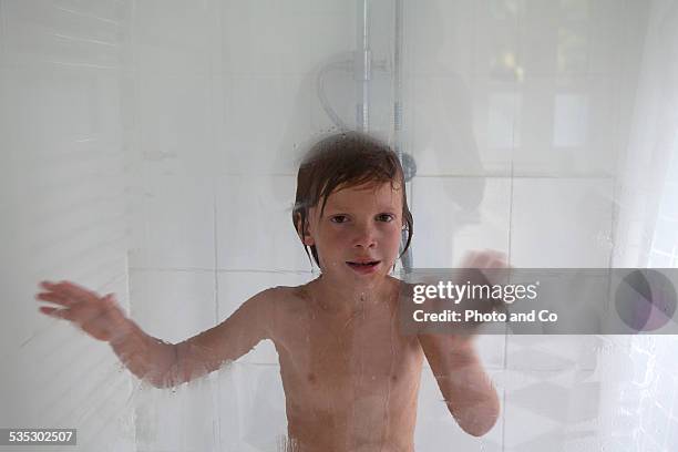 child in the shower - boy taking a shower stock-fotos und bilder