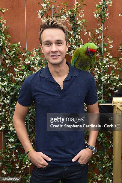 Cyril Feraud with a parrot attend day eight of the 2016 French Open at Roland Garros on May 29, 2016 in Paris, France.