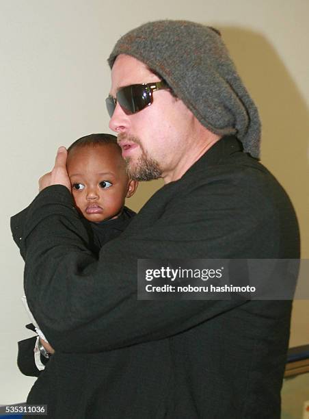 Actor Brad Pitt with actress/girlfriend Angelina Jolie, and her adopted child, Zahara, arrive at Narita International airport in Tokyo, to promote...