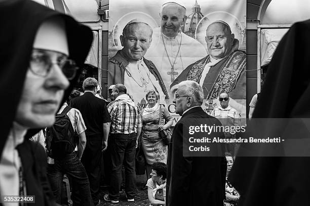 Nuns and Pilgrims gather aorund St. Peter's Square one day before the canonoization of John Paul II and John XXIII at the Vatican. The double...