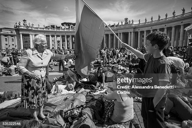Pilgrims gather in St. Peter's Square one day before the historical canonzation of Jonh Paul II and John XXIII.The double canonisation of two of...