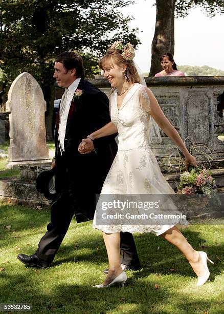 Musician Jools Holland and Christabel McEwen walk in the grounds after their wedding at St James's Church on August 30, 2005 in Cooling, England. The...