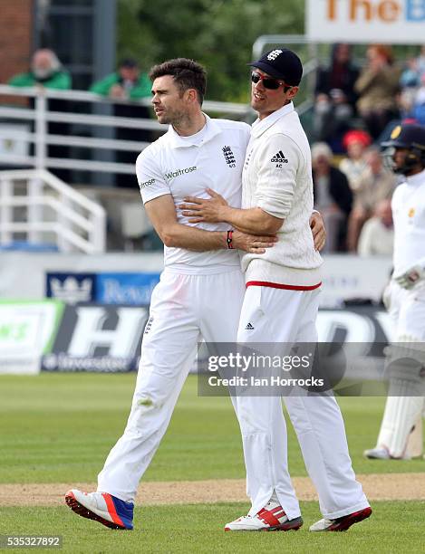 James Anderson of England celebrates the taking the wicket of Angelo Mathews with captain Alastair Cook during day three of the 2nd Investec Test...