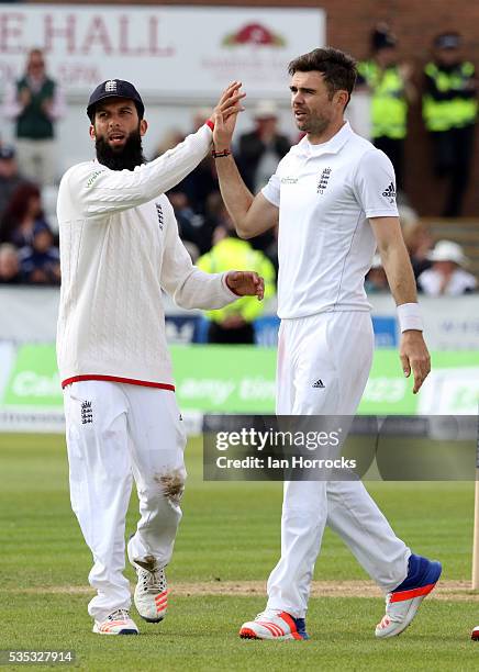 James Anderson of England celebrates taking the wicket of Angelo Mathews with Moeen Ali during day three of the 2nd Investec Test match between...