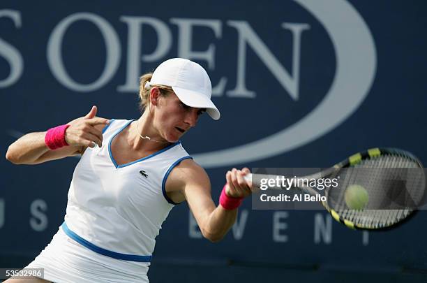 Emilie Loit of France returns a forehand to Ivana Lisjak of Croatia during the first round at the US Open at the USTA National Tennis Center in...