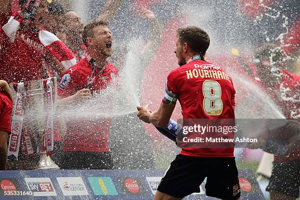 Conor Hourihane of Barnsley sprays champagne on his team mates as they celebrate promotion after winning the Sky Bet League One Play Off Final...