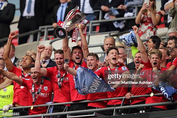 Barnsley players celebrate promotion after winning the Sky Bet League One Play Off Final between Barnsley and Millwall at Wembley Stadium on May 29,...