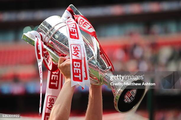 Barnsley hold up the trophy as they celebrate promotion after winning the Sky Bet League One Play Off Final between Barnsley and Millwall at Wembley...