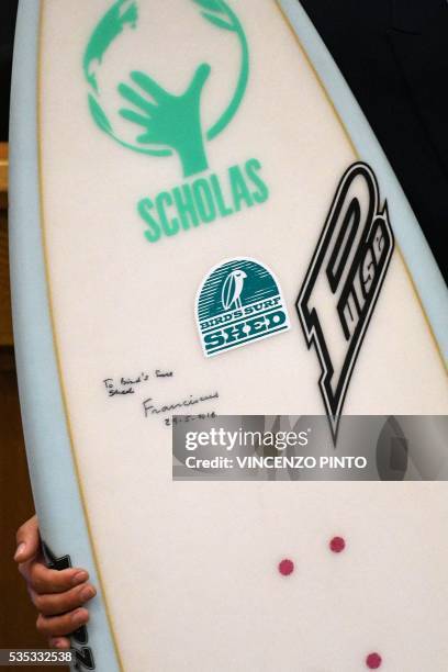 Picture shows the autograph of Pope Francis reading "to Bird's Surf Shed" on a surf board during a meeting with the participants of the Sixth World...