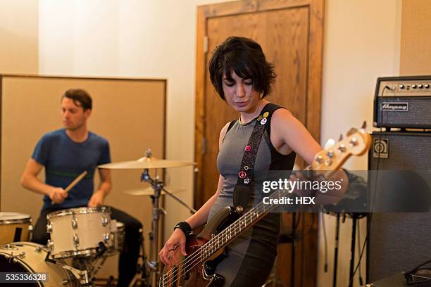 young musicians rehearsing at a studio space - bass stockfoto's en -beelden