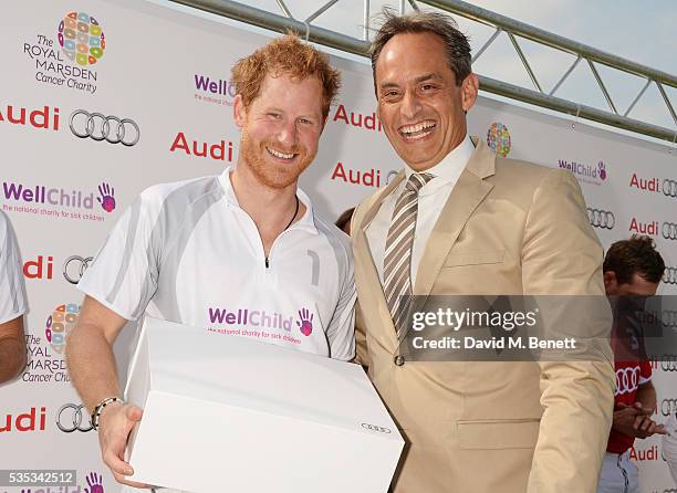 Prince Harry and Andre Konsbruck, Director of Audi UK, attend day two of the Audi Polo Challenge at Coworth Park on May 29, 2016 in London, England.