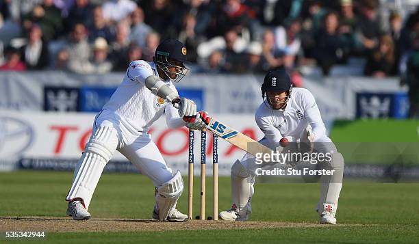 Sri Lanka batsman Milinda Siriwardana hits out as Jonny Bairstow looks on during day three of the 2nd Investec Test match between England and Sri...