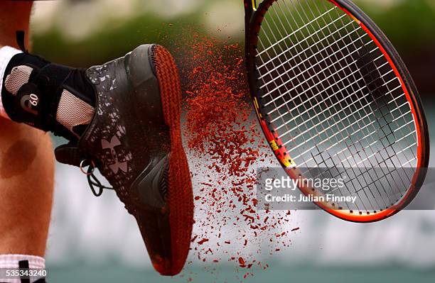 Andy Murray of Great Britain bangs clay from his shoes during the Men's Singles fourth round match against John Isner of the United States on day...