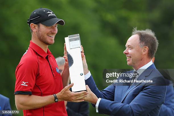 Chris Wood of England receives the trophy from Dr Ian Robertson, Member of the Board BMW AG Sales following his victory during day four of the BMW...