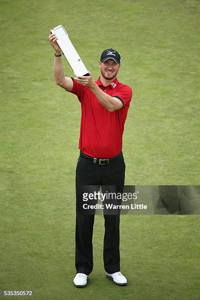Chris Wood of England poses with the trophy following his victory during day four of the BMW PGA Championship at Wentworth on May 29, 2016 in...