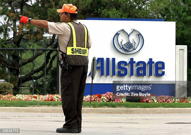 Member of the Cook County Sheriff's Police department directs traffic outside Allstate's corporate campus August 30, 2005 in Northbrook, Illinois....