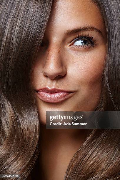 young beautiful female adult with long shiny hair - bräune stock-fotos und bilder