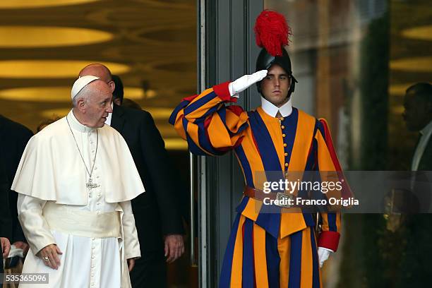 Pope Francis greets a Swiss Guard as he leaves at the end of 'Un Muro o Un Ponte' Seminary held by Pope Francis at the Paul VI Hall on May 29, 2016...