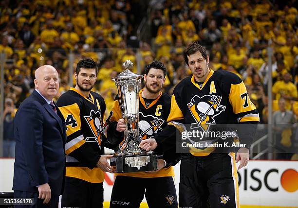 Deputy Commissioner Bill Daly presents Chris Kunitz, Sidney Crosby and Evgeni Malkin of the Pittsburgh Penguins with the Prince of Wales Trophy after...