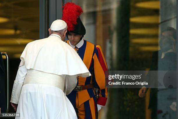 Pope Francis greets a Swiss Guard as he leaves at the end of 'Un Muro o Un Ponte' Seminary held by Pope Francis at the Paul VI Hall on May 29, 2016...