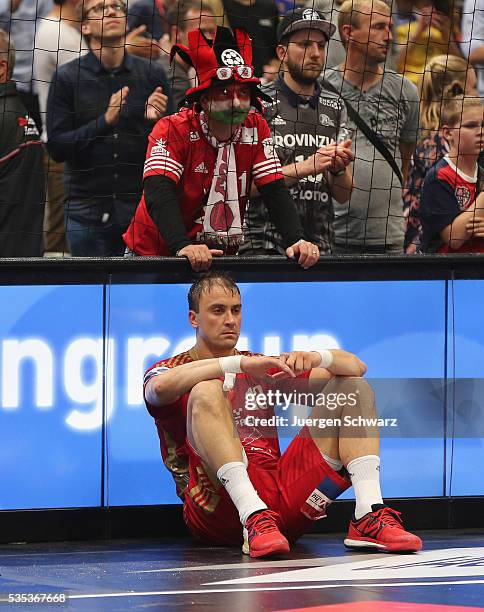 Momir Ilic of Veszprem sits in front of a supporter after losing the EHF Champions League Final against KS Vive Tauron Kielce on May 29, 2016 in...