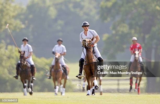 Prince Harry and Prince William, Duke of Cambridge take part in the Audi Polo Challenge at Coworth Park Polo Club on May 29, 2016 in Ascot, England.