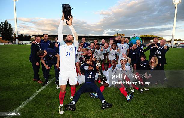 Nathan Redmond of England grabs a video camera and celebrates with the team during the Final of the Toulon Tournament between England and France at...
