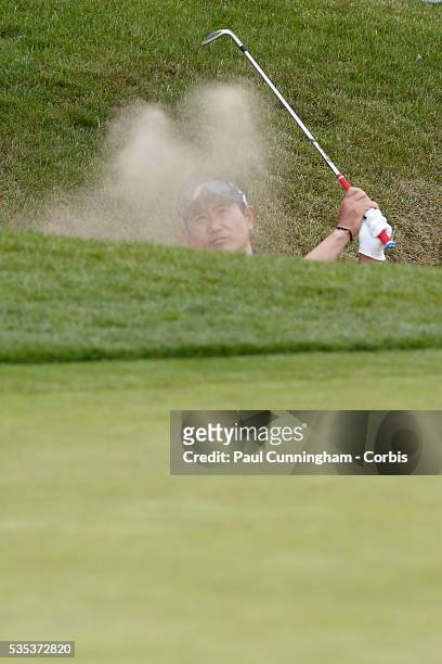 Yang hits a recovery shot from the deep bunker at the 18th green during day two of the BMW PGA Championship at Wentworth on May 27, 2016 in Virginia...
