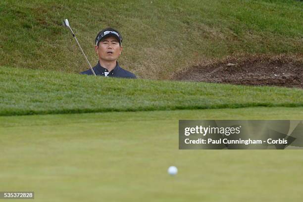 Yang hits a recovery shot from the deep bunker at the 18th green during day two of the BMW PGA Championship at Wentworth on May 27, 2016 in Virginia...