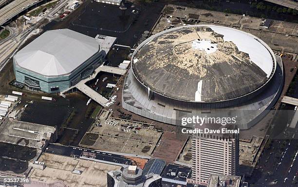 The damaged roof from Hurricane Katrina of the Louisiana Superdome is seen August 30, 2005 in New Orleans, Louisiana. Approximately 100 people are...