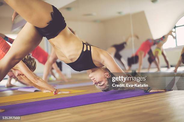 young women exercising yoga - hot yoga stock pictures, royalty-free photos & images