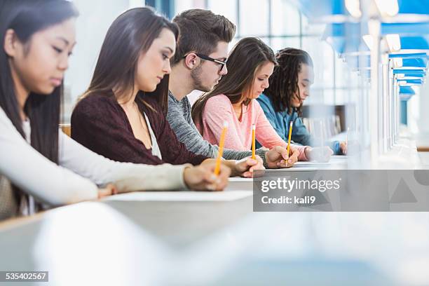 group of teenagers taking a test - gymnasieexamen bildbanksfoton och bilder