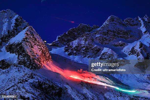 night skiing    passo tonale  glacier     lights in color  italian flag - night skiing stock pictures, royalty-free photos & images