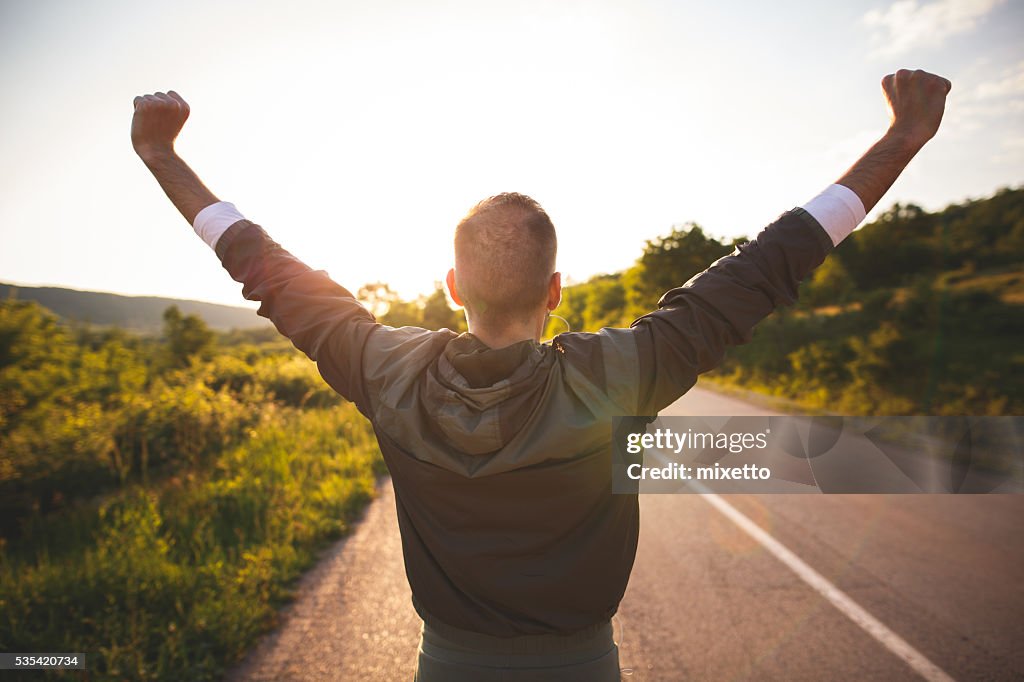Man raising arms