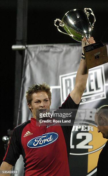 Crusaders captain Richie McCaw, holds aloft the Super 12 trophy after the 3525 defeat of the Waratahs in the rugby final at Jade Stadium,...