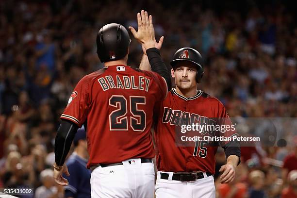 Phil Gosselin of the Arizona Diamondbacks high-fives Archie Bradley after both scored runs against the San Diego Padres during the second inning of...