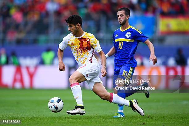Marco Asensio of Spain competes for the ball with Miralem Pjanic of Bosnia during an international friendly match between Spain and Bosnia at the AFG...