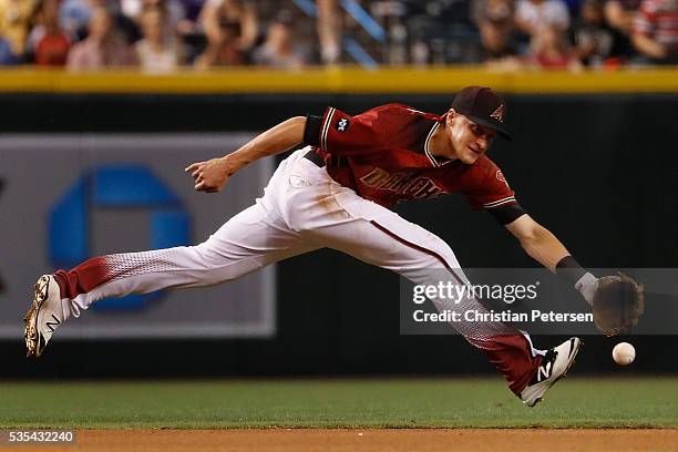 Infielder Nick Ahmed of the Arizona Diamondbacks fields a ground ball out against the San Diego Padres during the fourth inning of the MLB game at...