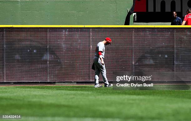 Picture of Keon Broxton of the Milwaukee Brewers lights up the scoreboard behind Tyler Holt of the Cincinnati Reds in the sixth inning at Miller Park...