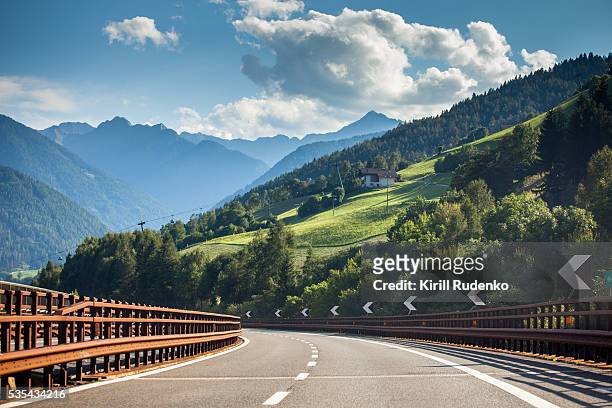 highway through italian alps - autostrada foto e immagini stock