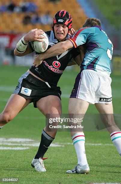 Richard Villasanti gets stopped in a tackle by Ben Pomeroy during the NRL rugby league, round 08 game between the New Zealand Warriors and the...