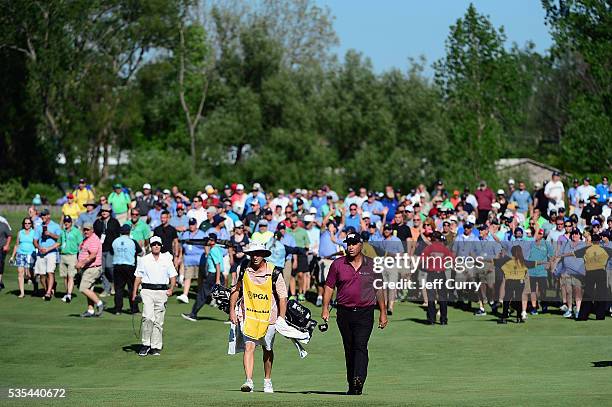 Rocco Mediate and his caddy walk to the 18th green as a crowd of fans follow during the final round of the 2016 Senior PGA Championship presented by...