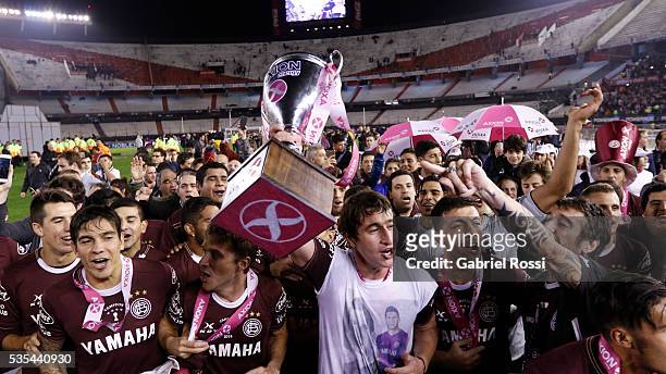 Nicolas Aguirre of Lanus celebrate with trophy after a final match between San Lorenzo and Lanus as part of Torneo Transicion 2016 at Monumental...