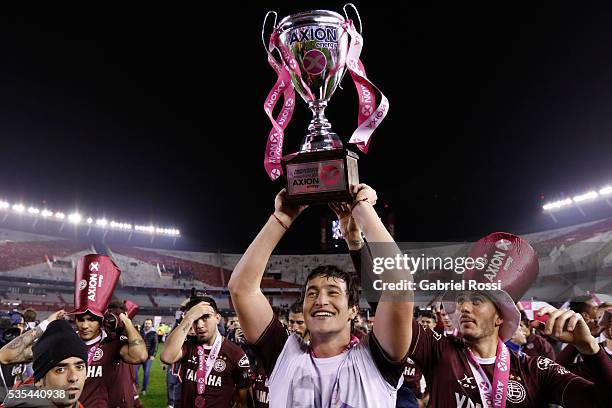 Nicolas Aguirre of Lanus celebrate with trophy after a final match between San Lorenzo and Lanus as part of Torneo Transicion 2016 at Monumental...